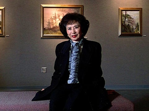 In this Nov. 28, 2000, file photo, March Fong Eu, former California Secretary of State, is seated among some of her paintings at California State University in Sacramento, Calif.